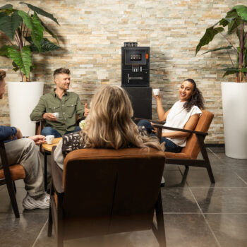 drei Menschen sitzen gemütlich in der Runde